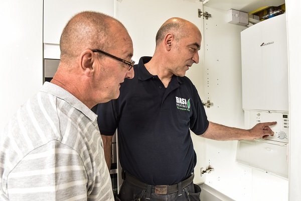 A BASI heating engineer working on a boiler installation